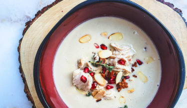 turkey cream soup with bacon, pine nuts, and pomegranate garnish